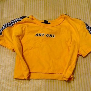 Checkered yellow crop top with print on it